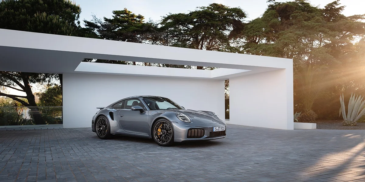 2026 Porsche 911 Turbo S parked in front of modern luxury home for sale in San Francisco, CA